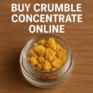 Glass jar filled with golden cannabis crumble concentrate on a wooden surface with “Buy Crumble Concentrate Online” text.